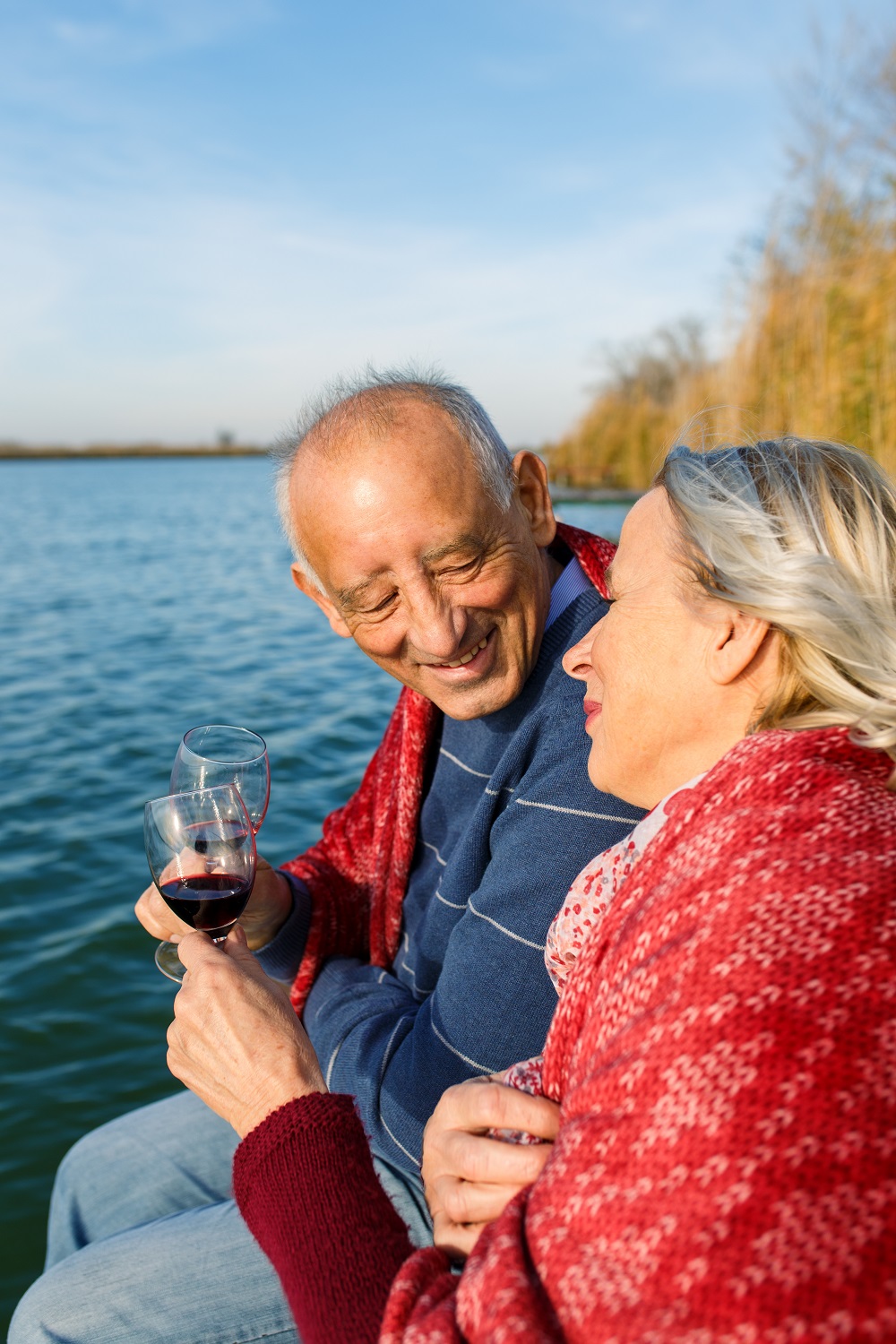 Happy senior couple enjoying time together by the lake.